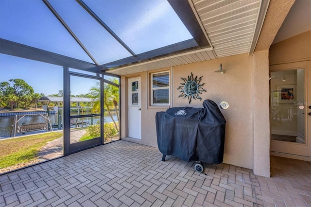 sunroom / solarium featuring a water view