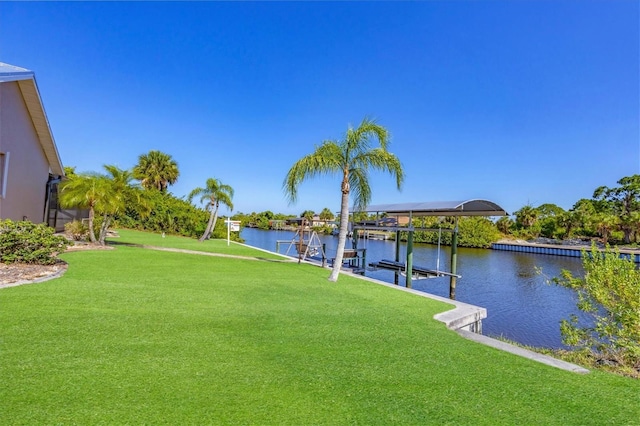 view of yard with a dock and a water view