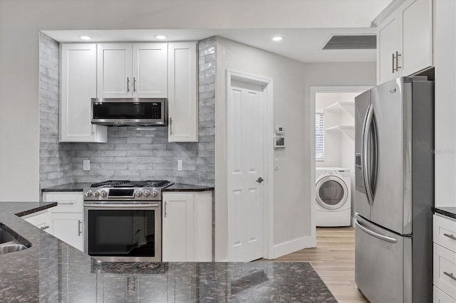 kitchen with white cabinetry, washer / clothes dryer, and appliances with stainless steel finishes