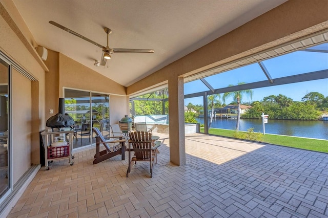 view of patio / terrace with a lanai, a water view, and ceiling fan