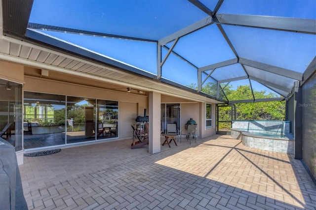 view of patio / terrace with ceiling fan and a lanai