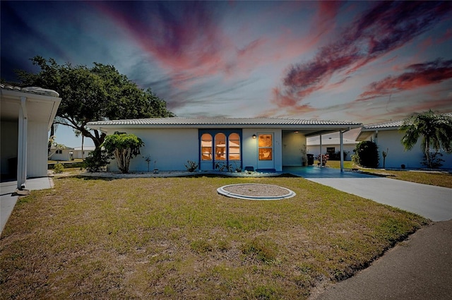 view of front of house with french doors and a lawn