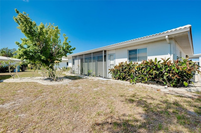 rear view of house featuring a yard