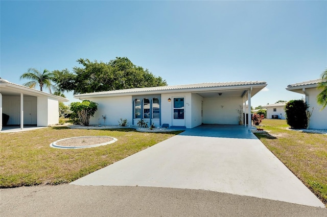 ranch-style home with a front lawn and a carport