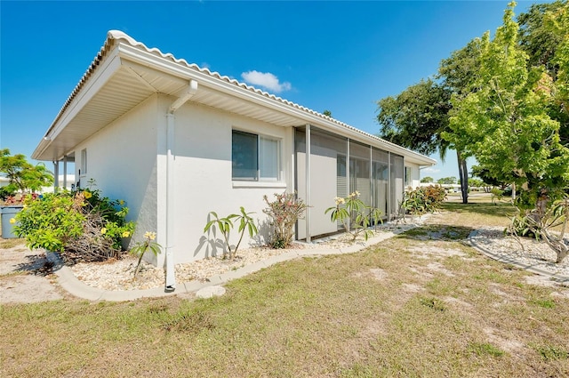 view of side of property with a lawn