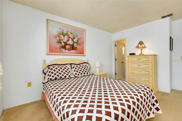 bedroom featuring carpet and a textured ceiling