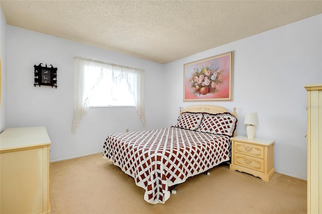 bedroom featuring a textured ceiling and carpet flooring