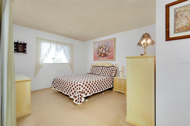 bedroom with carpet and a textured ceiling