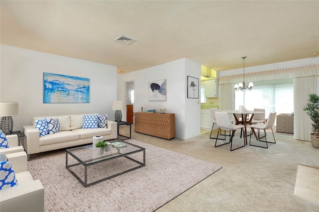 472 Circlewood Dr Unit L9, Venice, FL 34293 - living area featuring light carpet, a chandelier, and a textured ceiling