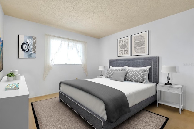 472 Circlewood Dr Unit L9, Venice, FL 34293 - bedroom featuring a textured ceiling and baseboards