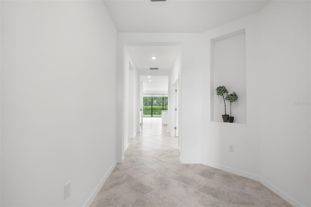 hall featuring light tile patterned flooring