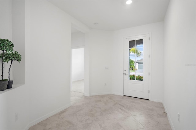 doorway with light tile patterned floors