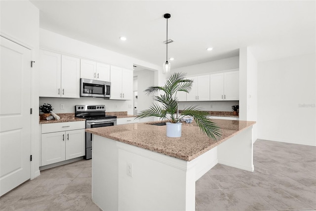 kitchen featuring a kitchen island, light stone countertops, pendant lighting, stainless steel appliances, and white cabinetry