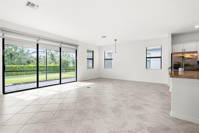 unfurnished living room featuring light tile patterned floors