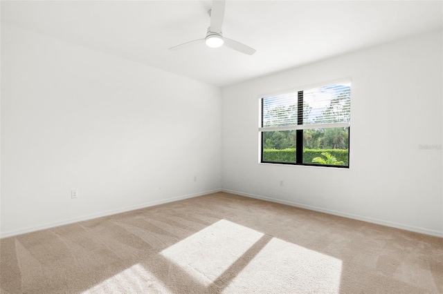 unfurnished room featuring ceiling fan and light carpet