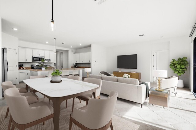 dining room with sink and light tile patterned flooring