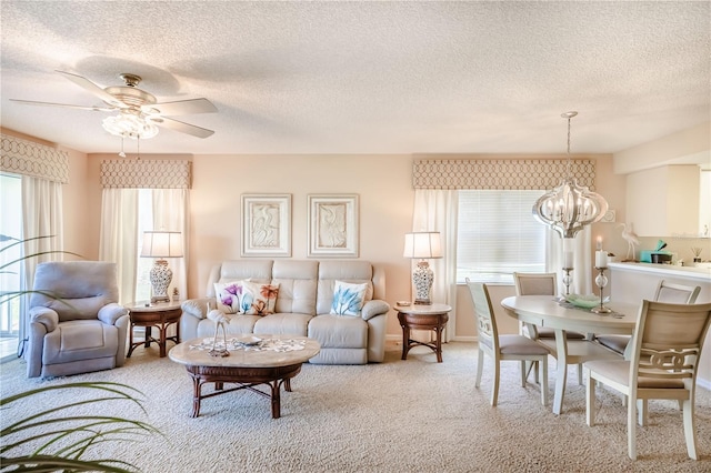 living room featuring carpet floors, a textured ceiling, and a wealth of natural light