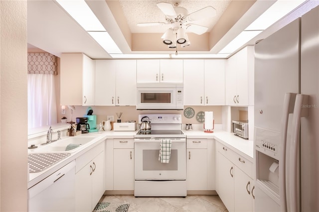 kitchen featuring white cabinets, white appliances, ceiling fan, and sink