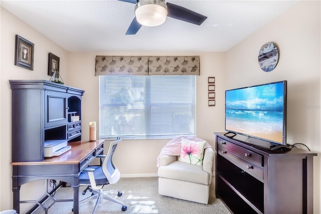 carpeted office space featuring a textured ceiling and ceiling fan