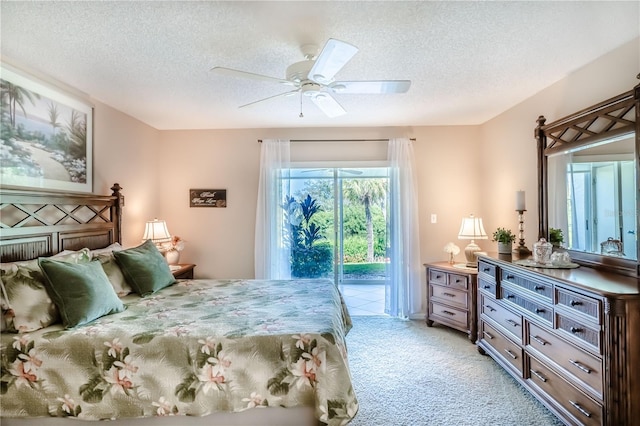 bedroom featuring access to exterior, a textured ceiling, light colored carpet, and ceiling fan