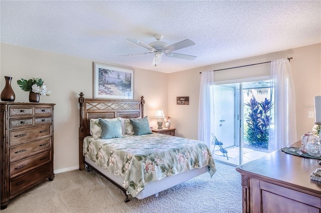 bedroom with a textured ceiling, access to outside, ceiling fan, and light colored carpet