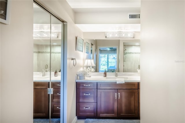 bathroom featuring vanity and a shower with shower door