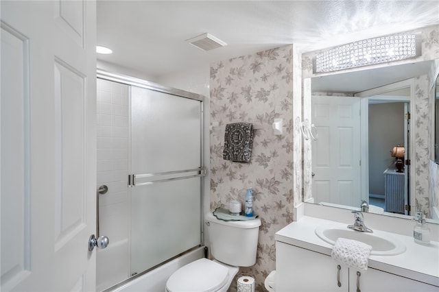 full bathroom featuring vanity, toilet, and enclosed tub / shower combo