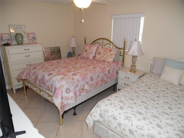 bedroom with ceiling fan and light tile patterned floors