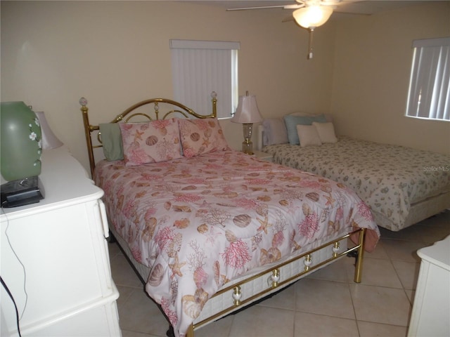 tiled bedroom with ceiling fan