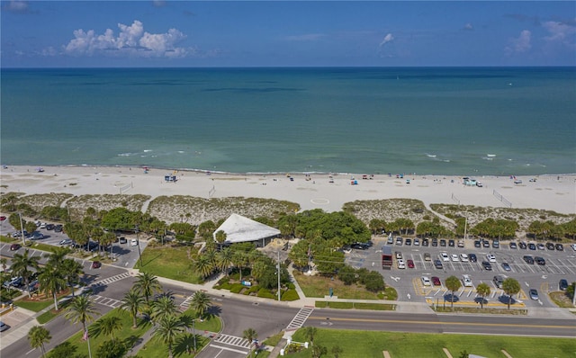 bird's eye view featuring a water view and a beach view