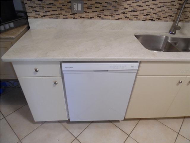 kitchen featuring dishwasher, white cabinets, light tile patterned floors, and sink