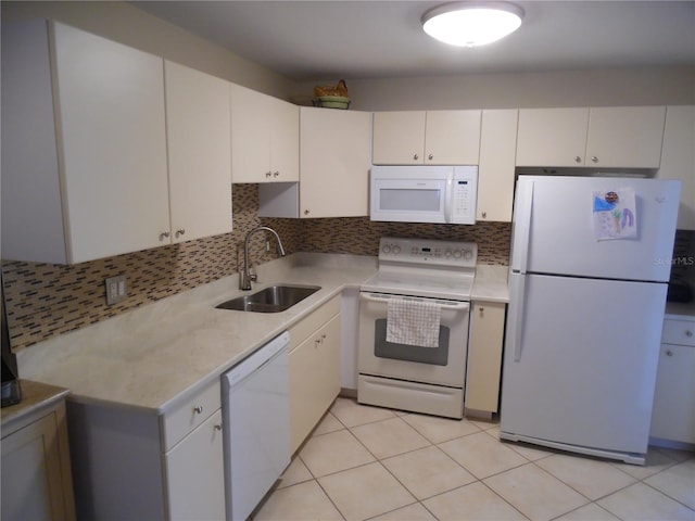 kitchen featuring white appliances, white cabinetry, and sink