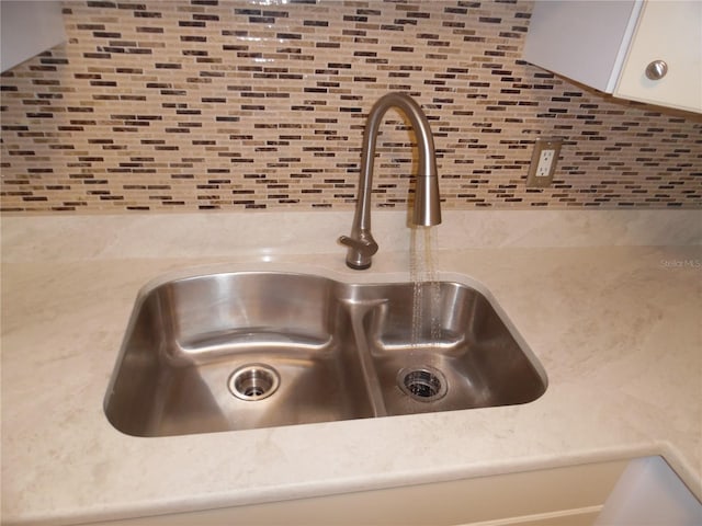 interior details with backsplash and sink