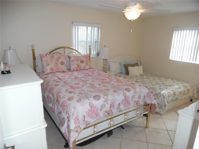 bedroom with ceiling fan and light tile patterned floors