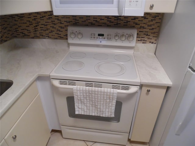 interior details featuring white appliances and tasteful backsplash