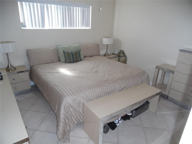 bedroom featuring light tile patterned floors and multiple windows