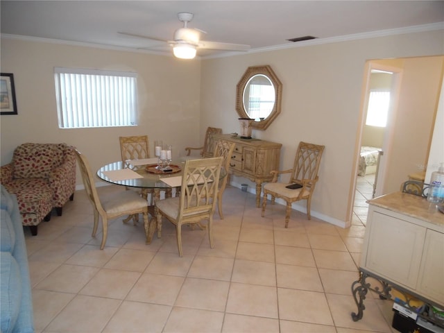 dining room featuring ceiling fan, light tile patterned floors, and crown molding