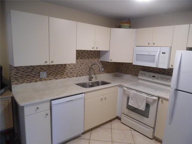 kitchen featuring white cabinets, white appliances, sink, and light tile patterned floors