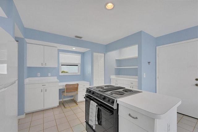 kitchen featuring white cabinetry, black electric range oven, a kitchen island, and white fridge