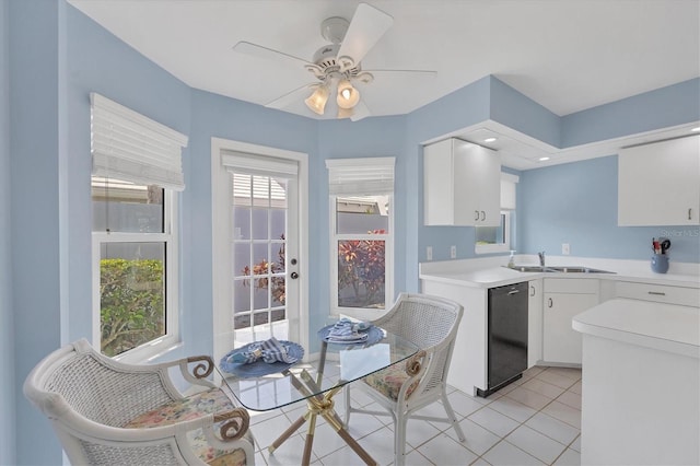 kitchen with ceiling fan, sink, light tile patterned floors, black dishwasher, and white cabinets