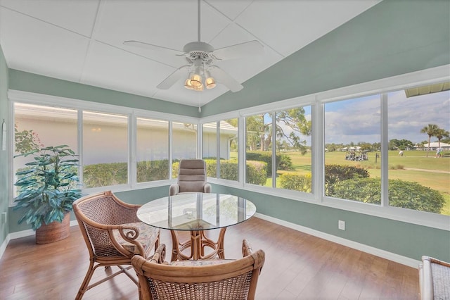 sunroom featuring ceiling fan, a healthy amount of sunlight, and lofted ceiling