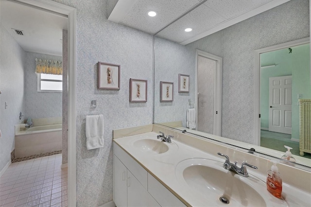 bathroom with vanity, tile patterned floors, and a tub