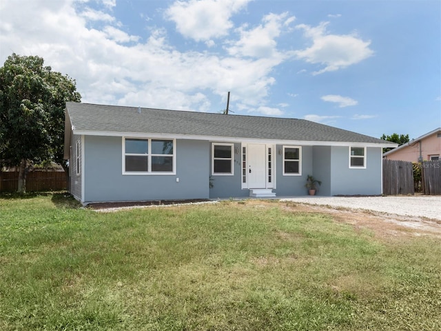 ranch-style home with a front lawn