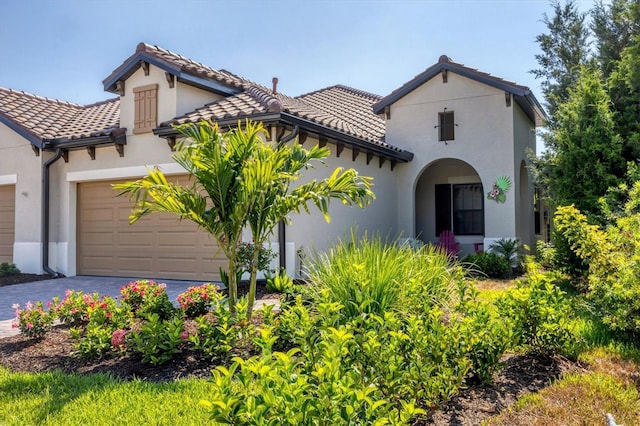 mediterranean / spanish home with a garage