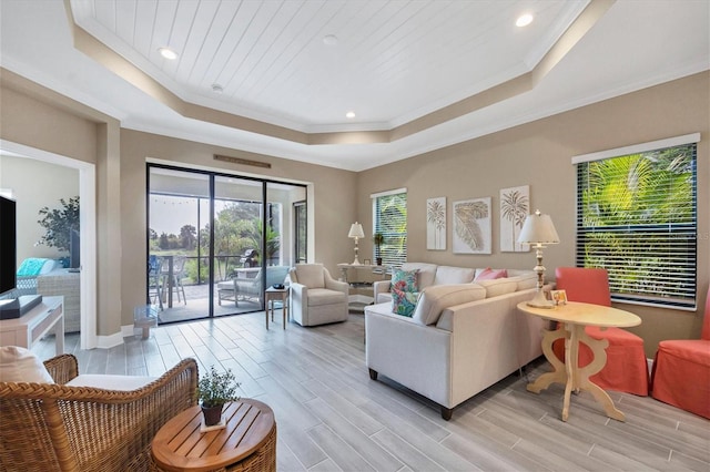 living room with crown molding, light wood-type flooring, a tray ceiling, and wooden ceiling