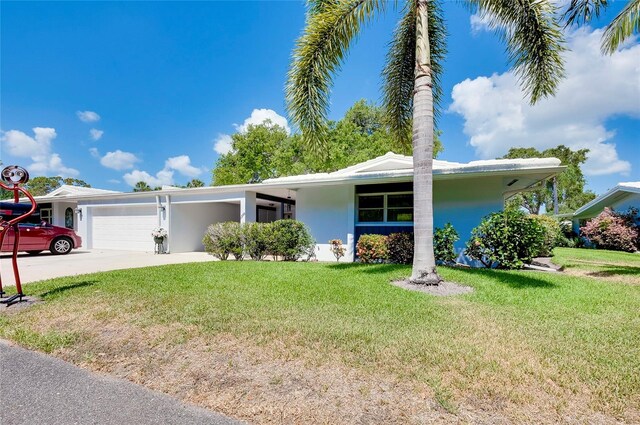 single story home with a garage and a front yard