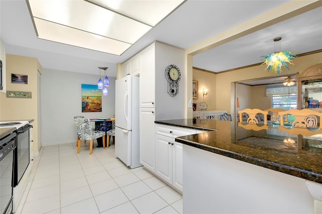 kitchen featuring white cabinetry, dark stone countertops, white refrigerator, light tile patterned floors, and pendant lighting