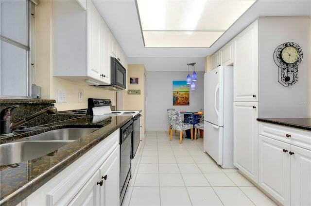 kitchen with dark stone countertops, white cabinetry, black appliances, and light tile floors