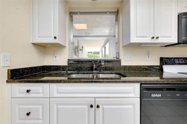 kitchen featuring white cabinetry, sink, dark stone counters, and black dishwasher