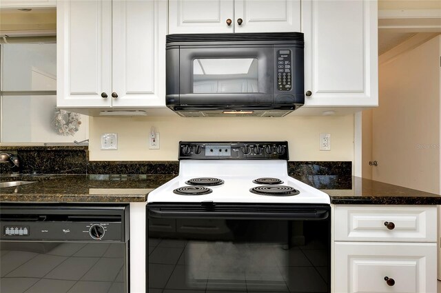 kitchen with dark stone countertops, white cabinets, and black appliances